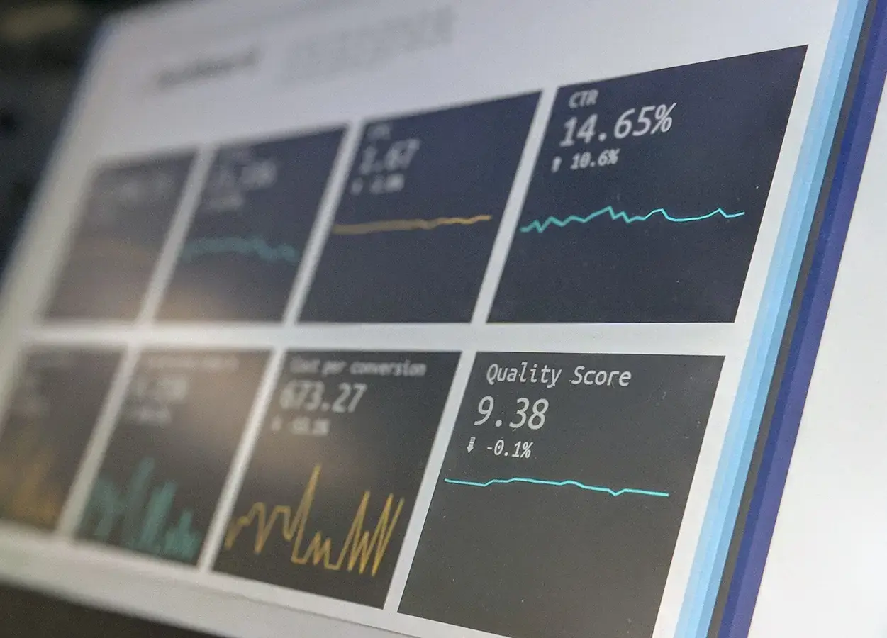 A close-up shot of a computer screen displaying a dashboard with various metrics, including CTR, cost per conversion, and quality score, suggesting data analysis or performance tracking.